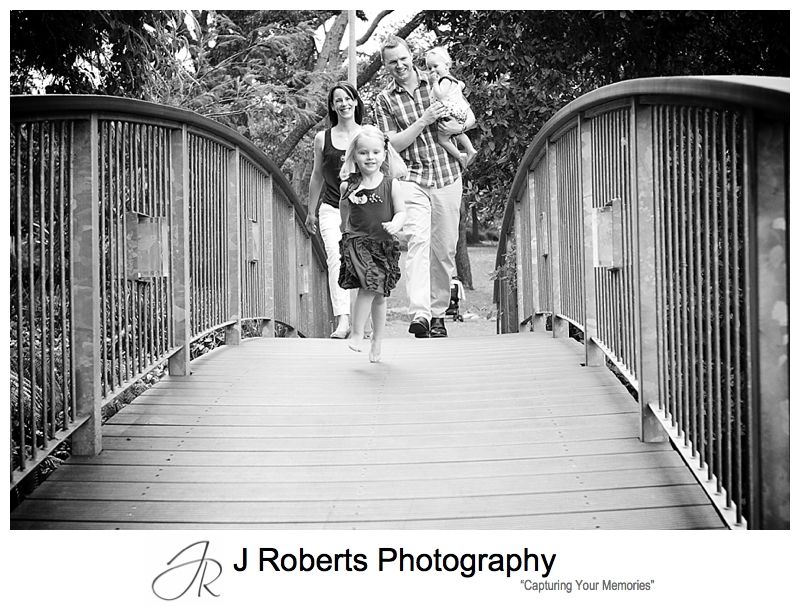 B&W portrait of a family walking across the bridge in Muston Park Roseville - sydney family portrait photography